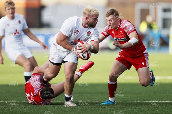 070721 - Wales U20s v England U20s - U20s 6 Nations Championship - Sam Riley of England is tackled by Daniel John and Sam Costelow of Wales
