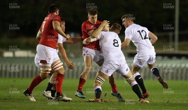 220219 - Wales U20s v England U20s - U20s 6 Nations Championship - Tomi Lewis of Wales is tackled by Tom Willis of England