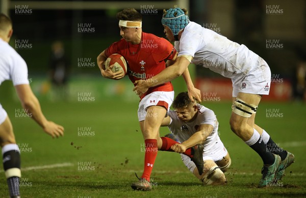 220219 - Wales U20s v England U20s - U20s 6 Nations Championship - Dafydd Buckland of Wales is tackled by Richard Capstick of England