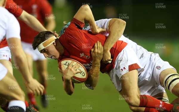 220219 - Wales U20s v England U20s - U20s 6 Nations Championship - Dafydd Buckland of Wales is tackled by Richard Capstick of England