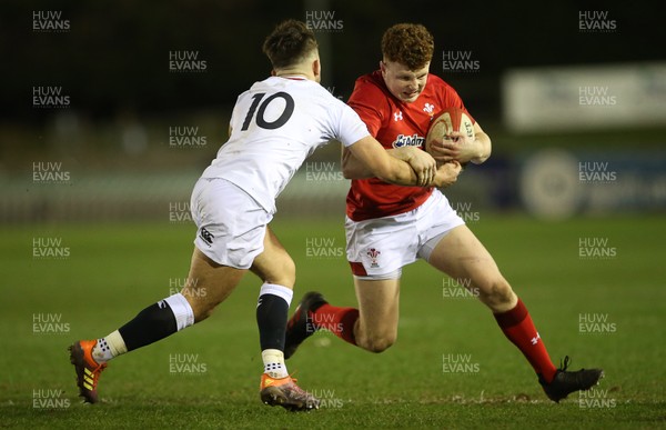 220219 - Wales U20s v England U20s - U20s 6 Nations Championship - Aneurin Owen of Wales is tackled by Kieran Wilkinson of England