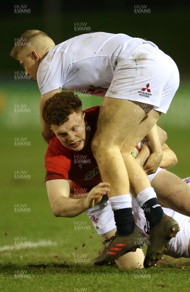 220219 - Wales U20s v England U20s - U20s 6 Nations Championship - Aneurin Owen of Wales is tackled by Kieran Wilkinson and Ollie Fox of England