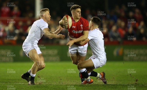 220219 - Wales U20s v England U20s - U20s 6 Nations Championship - Tomi Lewis of Wales is tackled by Kieran Wilkinson of England