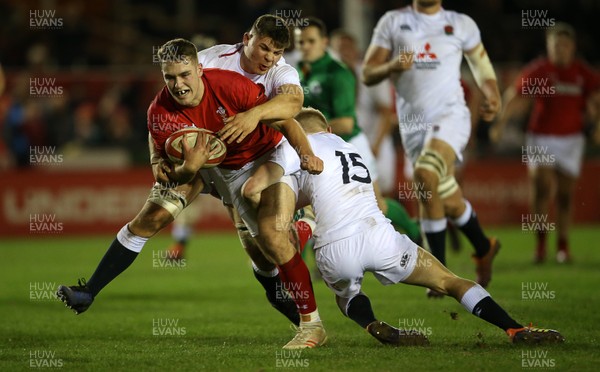 220219 - Wales U20s v England U20s - U20s 6 Nations Championship - Max Llewellyn of Wales is tackled by Aaron Hinkley and Josh Hodge of England just short of the line
