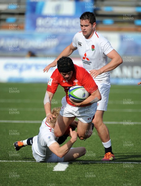 220619 - Wales U20 v England U20 - World Rugby Under 20 Championship - 5th Place Final - Ioan Davies of Wales beats the tackle of England's winger Josh Hodge