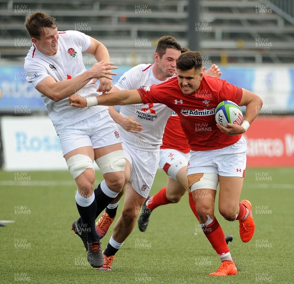 220619 - Wales U20 v England U20 - World Rugby Under 20 Championship - 5th Place Final - Tiaan Thomas-Wheeler of Wales hands off England U20 flanker Ted Hill