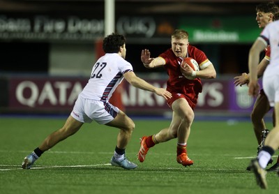 140325 - Wales U20s v England U20s - U20s Six Nations Championship - Harry Beddall of Wales is tackled by Josh Bellamy of England 