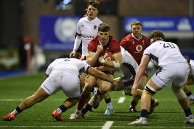 140325 - Wales U20 v England U20 - Six Nations Chamionship - Harry Rees-Weldon of Wales U20s is challenged by Kepu Tuipulotu of England U20s