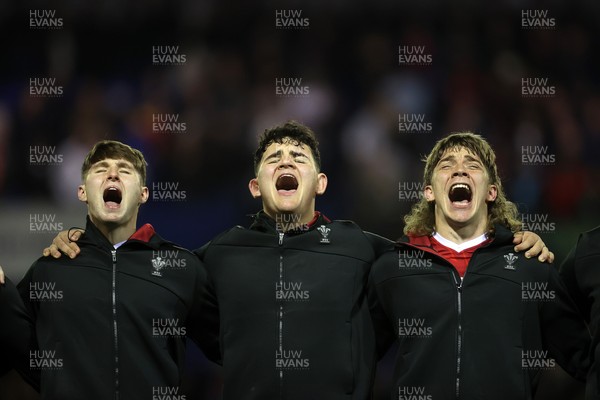 140325 - Wales U20s v England U20s - U20s Six Nations Championship - Steffan Emanuel, Sam Scott and Aidan Boshoff of Wales belt out the anthem