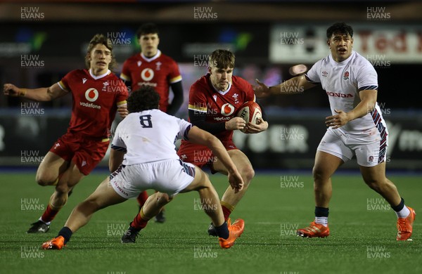 140325 - Wales U20s v England U20s - U20s Six Nations Championship - Steffan Emanuel of Wales is challenged by Kane James of England 