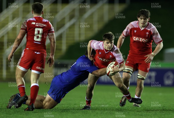 100322 - Wales U20s v France U20s - U20s 6 Nations Championship - Jac Lloyd of Wales is challenged by Matis Perchaud of France