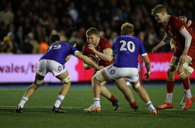 140226 - Wales U20s v France U20s - U20s Six Nations Championship - Isaac Godfrey of Wales is tackled by Portat Alban of France 