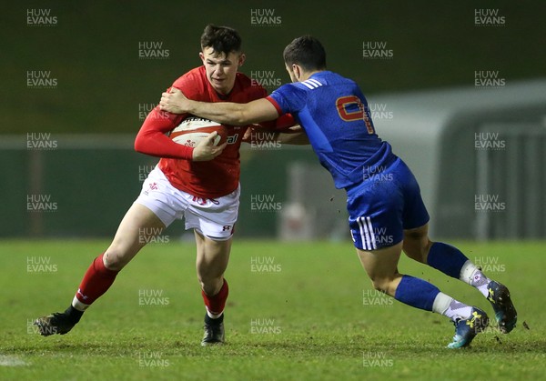 160318 - Wales U20s v France U20s - Natwest 6 Nations Championship - Tommy Rogers of Wales is tackled by Jules Gimbert of France