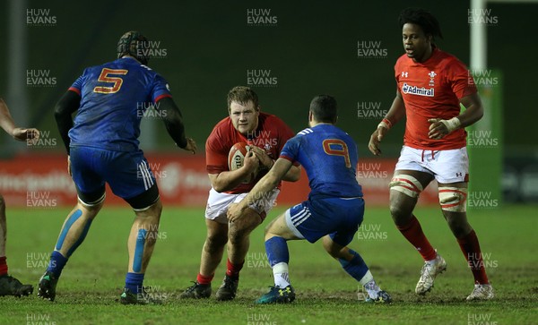 160318 - Wales U20s v France U20s - Natwest 6 Nations Championship - Rhys Henry of Wales is tackled by Jules Gimbert of France