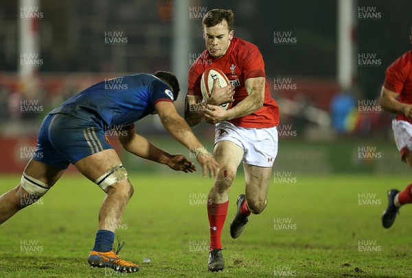 160318 - Wales U20s v France U20s - Natwest 6 Nations Championship - Cai Evans of Wales is tackled by Sacha Zegueur of France