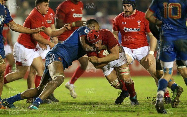 160318 - Wales U20s v France U20s - Natwest 6 Nations Championship - James Botham of Wales is tackled by Camero Woki of France