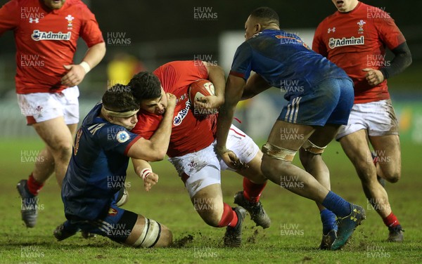 160318 - Wales U20s v France U20s - Natwest 6 Nations Championship - Josh Reynolds of Wales is tackled by Georges Colombe of France