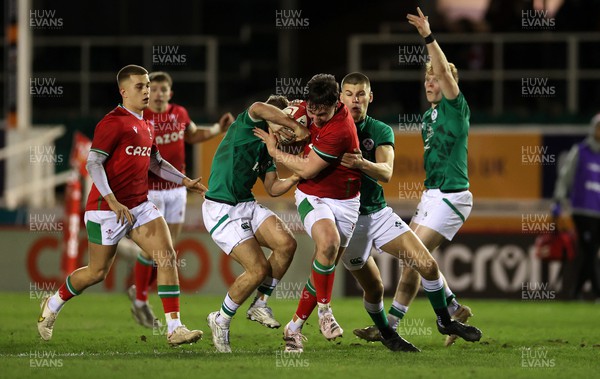 030223 - Wales U20s v Ireland U20s - U20s 6 Nations Championship - Harri Ackerman of Wales is tackled by Fintan Gunne and Sam Prendergast of Ireland 