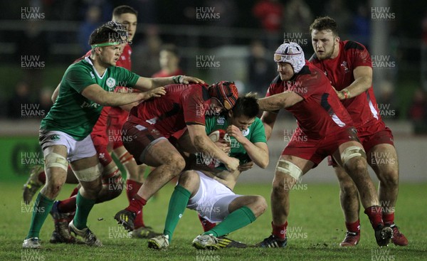 130315 - Wales U20s v Ireland U20s - RBS 6 Nations - Ross Byrne of Ireland is tackled by Ryan Elias of Wales