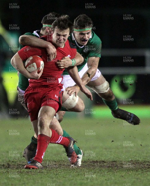 130315 - Wales U20s v Ireland U20s - RBS 6 Nations - Jarrod Evans of Wales is tackled by Josh Murphy and Conor Oliver of Ireland