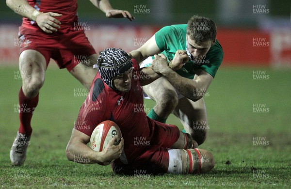 130315 - Wales U20s v Ireland U20s - RBS 6 Nations - Ollie Griffiths of Wales is tackled by Stephen Fitzgerald of Ireland