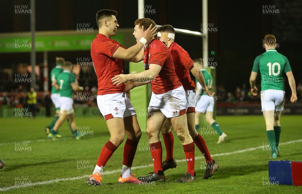 150319 - Wales U20s v Ireland U20s - U20s 6 Nations Championship - Aneurin Owen of Wales celebrates scoring a try with Tiaan Thomas-Wheeler and Dafydd Buckland