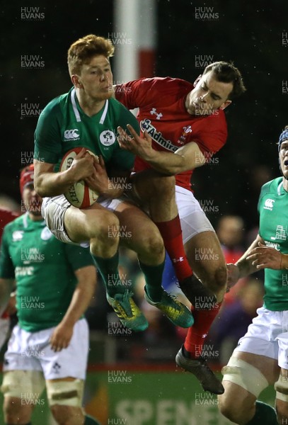 150319 - Wales U20s v Ireland U20s - U20s 6 Nations Championship - Ben Healy of Ireland and Cai Evans of Wales go high for the ball