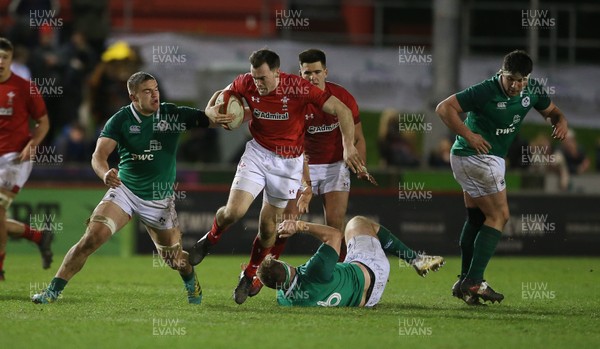 150319 - Wales U20s v Ireland U20s - U20s 6 Nations Championship - Sam Costelow of Wales is tackled by Martin Moloney of Ireland