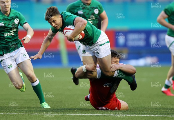 250621 - Wales U20s v Ireland U20s - U20s 6 Nations Championship - Tim Corkery of Ireland is tackled by Oliver Burrows of Wales