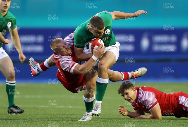 250621 - Wales U20s v Ireland U20s - U20s 6 Nations Championship - Ben Moxham of Ireland is tackled by Ioan Evans of Wales