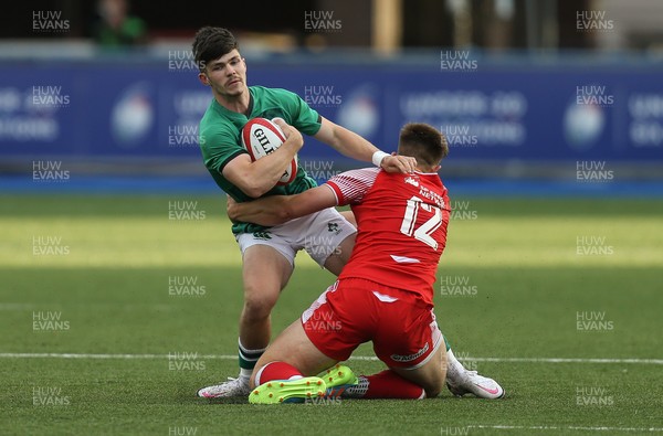250621 - Wales U20 v Ireland U20, U20 Six Nations - Chris Cosgrave of Ireland is tackled by Joe Hawkins of Wales