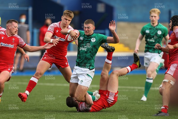 250621 - Wales U20 v Ireland U20, U20 Six Nations - Ben Moxham of Ireland is tackled by Dan John of Wales