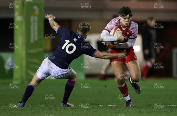110222 - Wales U20s v Scotland U20s - U20s Six Nations Championship - Eddie James of Wales is tackled by Christian Townsend of Scotland