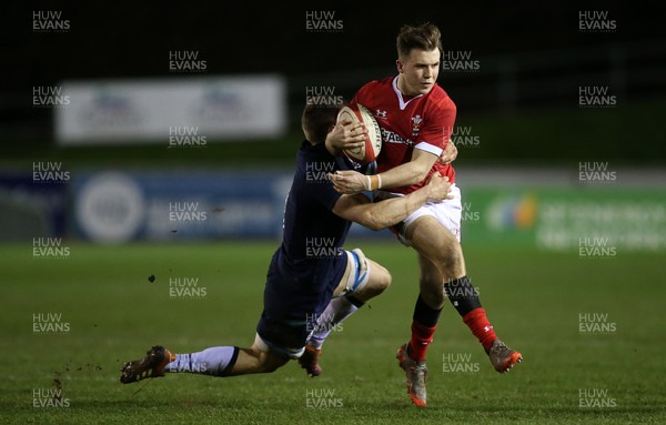 130320 - Wales U20s v Scotland U20s - U20s 6 Nations Championship - Ioan Lloyd of Wales is tackled by Rory Darge of Scotland