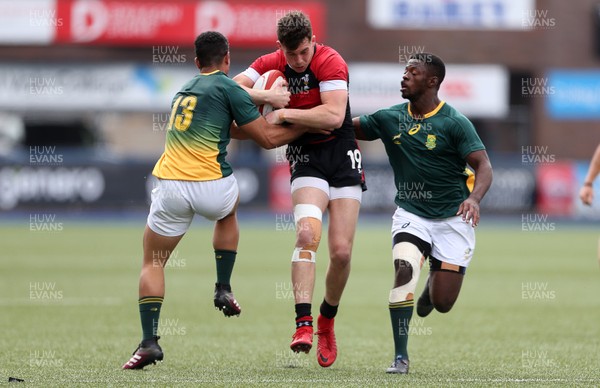 080518 - Wales U20s v South Africa U20s - International Friendly - Joe Goodchild of Wales is tackled by Manuel Rass and Lubabalo Dobela of South Africa