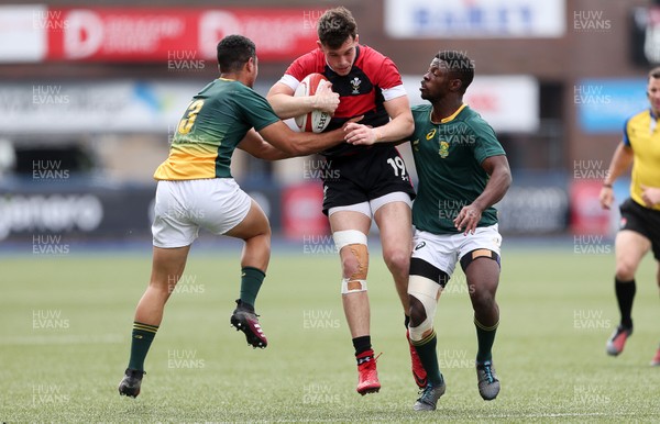 080518 - Wales U20s v South Africa U20s - International Friendly - Joe Goodchild of Wales is tackled by Manuel Rass and Lubabalo Dobela of South Africa