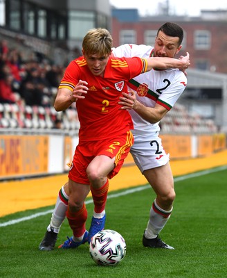 290322 - Wales U21 v Bulgaria U21 - 2023 UEFA Under 21 Euro Qualifying Round - Finley Stevens of Wales is challenged by Viktor Popov