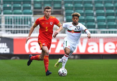 290322 - Wales U21 v Bulgaria U21 - 2023 UEFA Under 21 Euro Qualifying Round - Ryan Astley of Wales is tackled by Sylvester Jasper of Bulgaria
