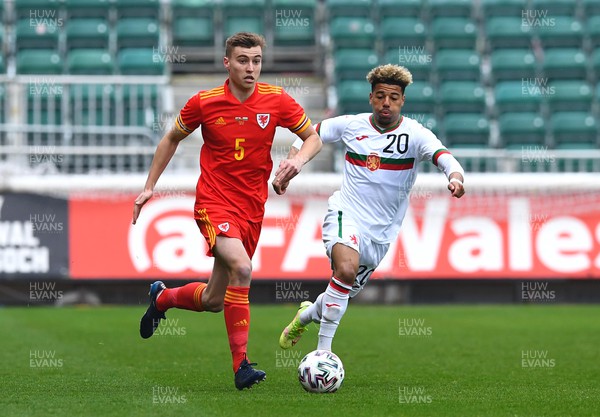 290322 - Wales U21 v Bulgaria U21 - 2023 UEFA Under 21 Euro Qualifying Round - Ryan Astley of Wales is tackled by Sylvester Jasper of Bulgaria