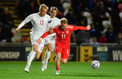 201123 - Wales U21 v Denmark U21 - European Under-21 Championship 2025 Qualifier - Oliver Nielsen of Denmark is tackled by Joe Taylor of Wales