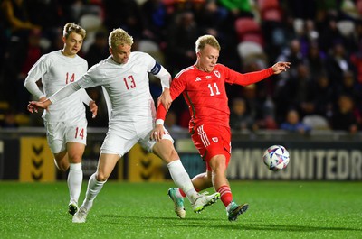 201123 - Wales U21 v Denmark U21 - European Under-21 Championship 2025 Qualifier - Oliver Nielsen of Denmark is tackled by Joe Taylor of Wales