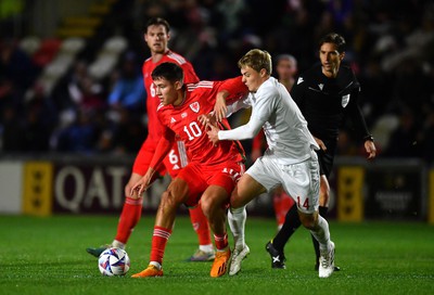 201123 - Wales U21 v Denmark U21 - European Under-21 Championship 2025 Qualifier - Rubin Colwill of Wales is tackled by David Kruse of Denmark