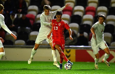 201123 - Wales U21 v Denmark U21 - European Under-21 Championship 2025 Qualifier - Luke Harris of Wales is tackled by David Kruse of Denmark
