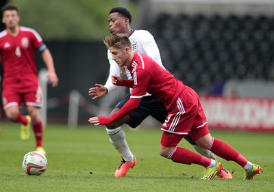 190514 - Wales U21 v England U21 - UEFA Under 21 Qualifying Match - Wes Burns of Wales is tackled by Jesse Lingard of England  