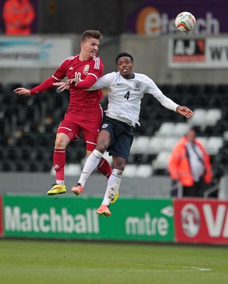 190514 - Wales U21 v England U21 - UEFA Under 21 Qualifying Match - Lee Evans of Wales and Jesse Lingard of England go up for the ball 