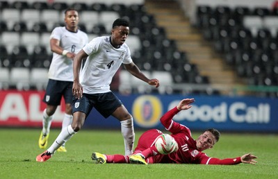190514 - Wales U21 v England U21 - UEFA Under 21 Qualifying Match - Lee Evans of Wales challenges Nat Chalobath of England for the ball 