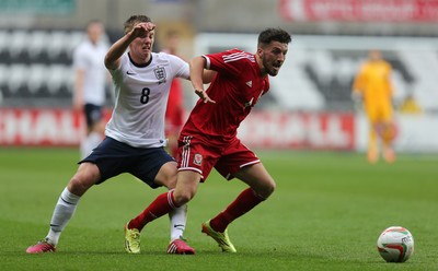 190514 - Wales v England, UEFA Under 21 Qualifying Match, Liberty Stadium, Swansea - Wales' Lee Lucas holds off England's James Ward-Prowse