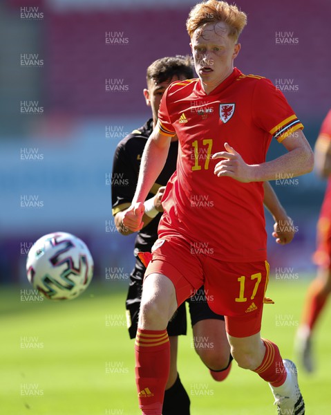 140622 - Wales U21 v Gibraltar U21, Under 21 European Championship Qualifying -Oli Hammond of Wales wins the ball ahead of Luke Bautista of Gibraltar