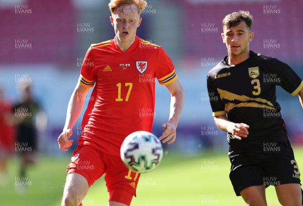 140622 - Wales U21 v Gibraltar U21, Under 21 European Championship Qualifying -Oli Hammond of Wales wins the ball ahead of Luke Bautista of Gibraltar