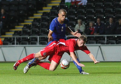 04.09.09 - Wales U21 v Italy U21, UEFA Under 21 Championship 2011 -  Wales' Simon Church is brought down by Italy's Giuseppe Bellusci  